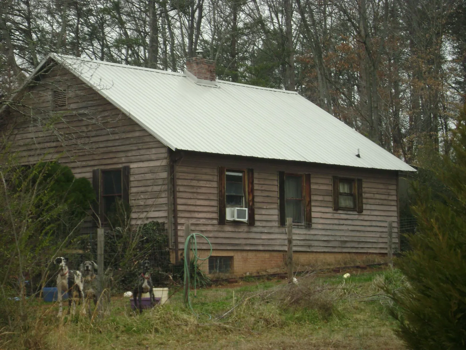 White metal roof on an old wood sided farmhouse, from a Metal Roof Installation job in Reseda